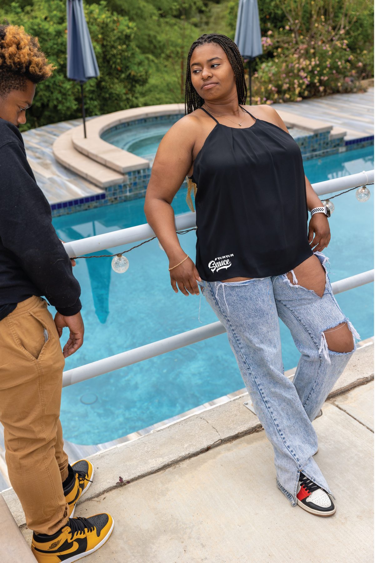 A woman standing next to a man near a pool.