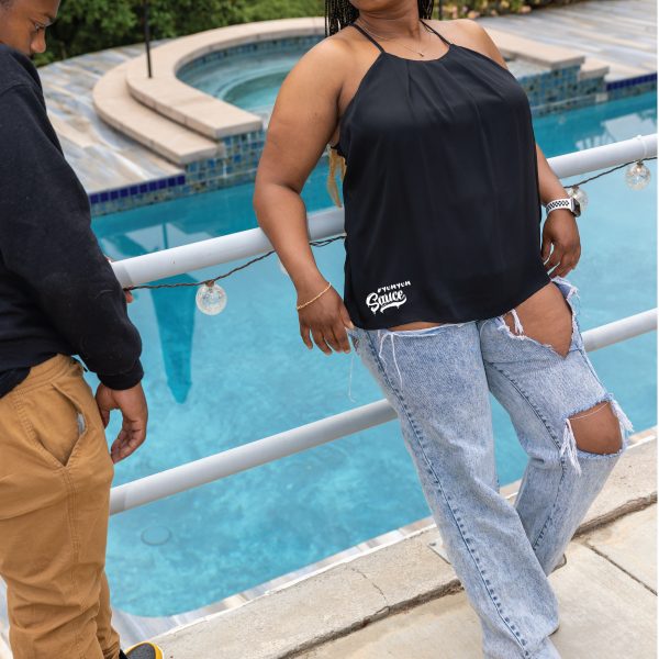 A woman standing next to a man near a pool.